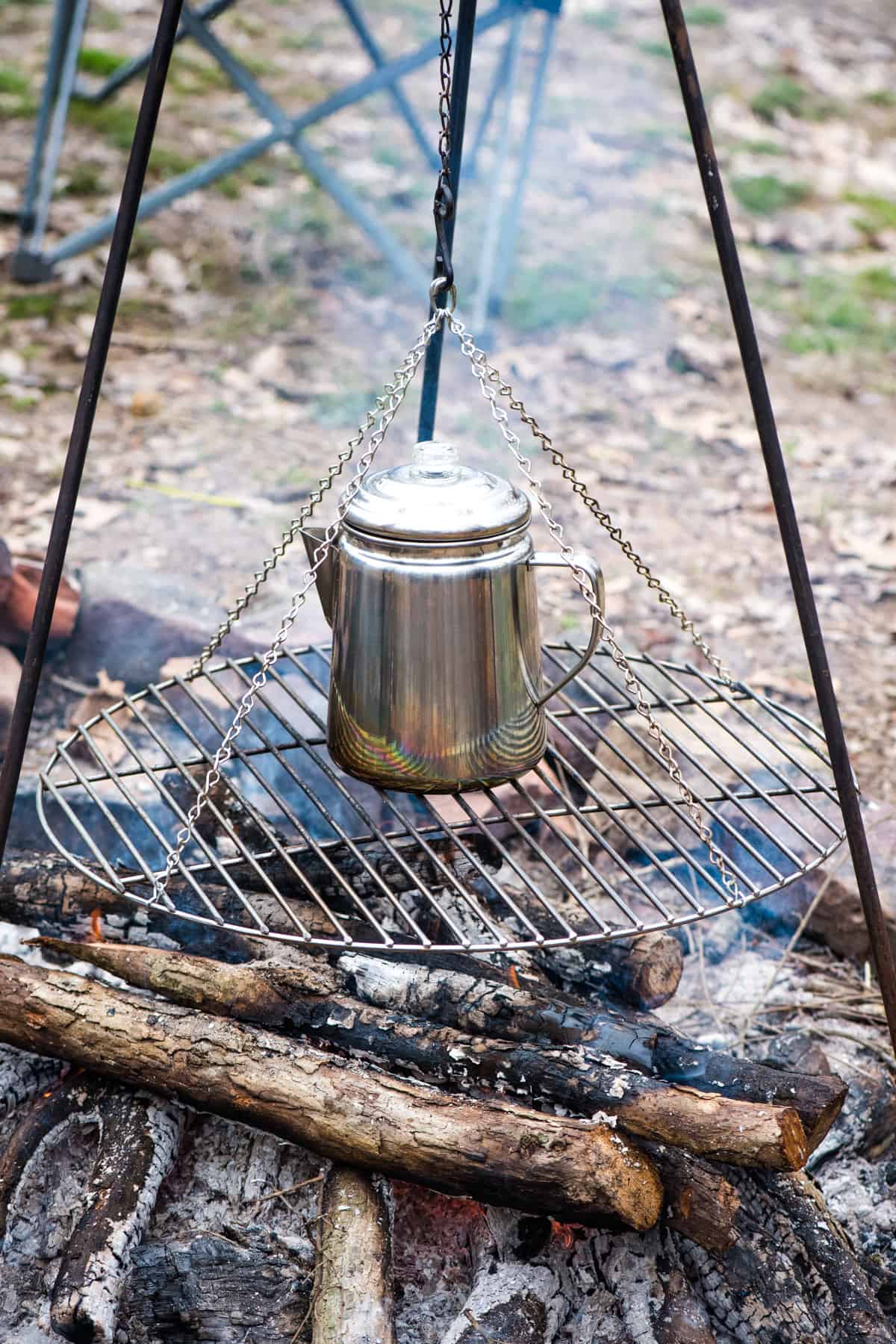 Coffee pot on tripod over a real fire