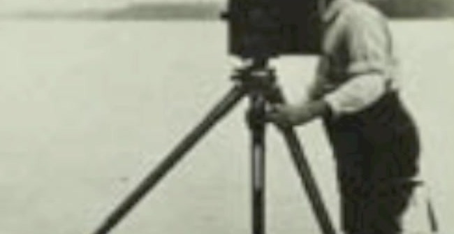 Curtis photographing with tripod camera